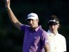 Dustin Johnson acknowledges the crowd after hitting an eagle on the 18th hole during the second round at the Tournament of Champions PGA golf tournament as Bubba Watson watches, Monday, Jan. 7, 2013, in Kapalua, Hawaii. (AP Photo/Elaine Thompson)