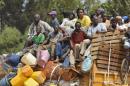 Chadian civilians sit in the back of trucks in the 4th district of Bangui as they flee the city on December 28, 2013