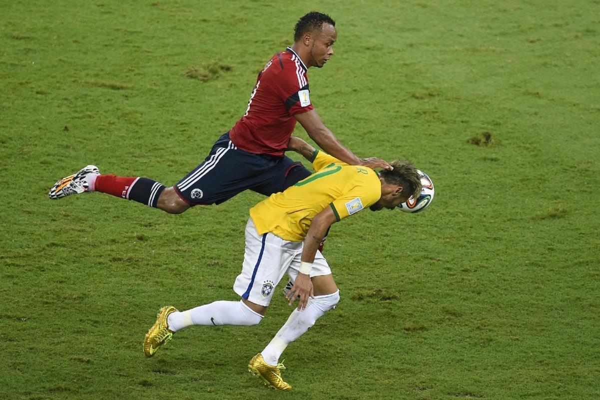 Juan Camilo Zuniga (left) challenges Neymar during the World Cup quarter-final between Brazil and Colombia in Fortaleza on July 4, 2014