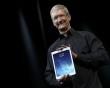 Apple Inc CEO Tim Cook holds up the new iPad Air during an Apple event in San Francisco