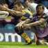 Melbourne Storm centre Michael Auld (right) is denied a scoring opportunity by Rhinos winger Ryan Hall (left) in 2010