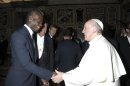 Italian national soccer player Mario Balotelli shakes hands with Pope Francis during a private audience at the Vatican
