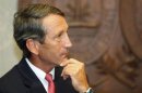 South Carolina Governor Mark Sanford pauses as he addresses the media at a news conference at the State House in Columbia