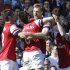 Arsenal players celebrate with their teammate Per Mertesacker, 2nd right, after he scored against Fulham during their English Premier League soccer match at the Craven Cottage ground in London, Saturday, April 20, 2013. Arsenal won the match 1-0.(AP Photo/Lefteris Pitarakis)
