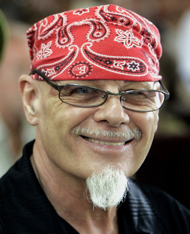 FILE - In this March 3, 2006 file photo, former British rocker Gary Glitter smiles at journalists prior to his verdict and sentencing at Ba Ria-Vung, Vung Tau province People's Court in Vietnam. Police investigating a sex abuse scandal surrounding late BBC television host Jimmy Savile have arrested pop star Gary Glitter in connection to the case, British media said Sunday, Oct. 28, 2012. Metropolitan Police said they arrested a man in his 60s early Sunday morning at his London home, on suspicion of sexual offenses. The force did not identify the man, but British media including the BBC and Press Association reported he was Glitter, 68, a former rock musician and a convicted sex offender. Glitter's real name is Paul Gadd. (AP Photo/Richard Vogel, File)