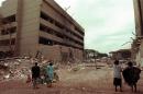 This August 1998 picture shows Kenyan residents looking at the US embassy (L) days after the August 7 bomb blast that killed at least 224 people