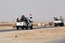 Iraqi Shiite fighters drive near the city of Udame on September 1, 2014