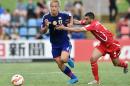 Keisuke Honda of Japan (L) is fouled by Ahmed Mahajna of Palestine (R) during their Group D football match of the AFC Asian Cup in Newcastle, January 12, 2015