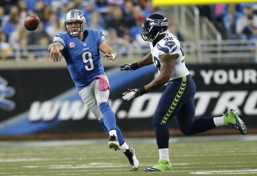 Detroit Lions quarterback Matthew Stafford (9) passes as Seattle Seahawks defensive end Greg Scruggs (98)approaches in the second half of an NFL football game, Sunday, Oct. 28, 2012. in Detroit. (AP Photo/Rick Osentoski)