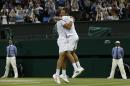 Canada's Vasek Pospisil (L) and US player Jack Sock celebrate winning their men's doubles final match against US players Bob and Mike Bryan at The All England Tennis Club in Wimbledon, southwest London, on July 5, 2014