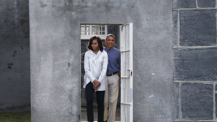 U.S. President Obama and the First lady tour the cell block on Robben Island where Mandela was held captive near Cape Town
