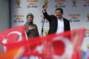 Turkish Prime Minister and Justice and Development (AK) party leader, Ahmet Davutoglu (R), and his wife Sare wave during an election campaign rally in Ankara on October 31, 2015