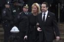 New York Gov. Andrew Cuomo, center, and girlfriend Sandra Lee leave the wake of New York Police Department Officer Wenjian Liu at Aievoli Funeral Home, Saturday, Jan. 3, 2015, in the Brooklyn borough of New York. Liu and his partner, Officer Rafael Ramos, were killed Dec. 20, as they sat in their patrol car on a Brooklyn street. The shooter, Ismaaiyl Brinsley, later killed himself. (AP Photo/John Minchillo)