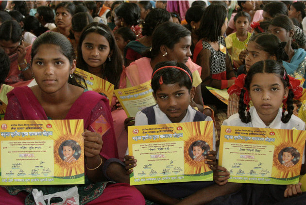 Girls hold certificates stating their new official names during a renaming ceremony  in Satara, India, Saturday, Oct. 22, 2011. Almost 300 Indian girls known officially as "Unwanted" have traded their