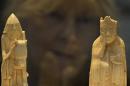 A woman views the 'Lewis Chessmen' at the British Museum in London