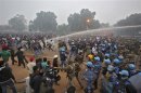 Police chase and use water canons on demonstraters during a protest in front of India Gate in New Delhi
