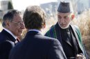 Karzai walks alongside Panetta on a guided tour of the Pentagon Memorial at the Pentagon in Arlington, Virginia