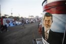 A poster of deposed Egyptian President Mursi is seen as supporters wait to break fast on first day of Ramadan in Cairo