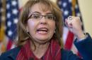FILE - In this March 4, 2015, file photo, former U.S. Rep. Gabrielle "Gabby" Giffords of Arizona gestures as she speaks on Capitol Hill in Washington. Giffords is being recognized with a Navy ship named in her honor at a shipyard in Mobile, Alabama. Giffords is set to attend the Saturday, June 13, 2015, christening of the USS Gabrielle Giffords. (AP Photo/Carolyn Kaster, File)