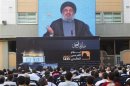 Lebanon's Hezbollah leader Sayyed Hassan Nasrallah addresses his supporters via a screen, during a rally marking "Quds (Jerusalem) Day",in the southern suburbs of Beirut