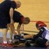 Britain's Philip Hindes sits on the ground after falling during their track cycling men's team sprint qualifying heats at the Velodrome during the London 2012 Olympic Games