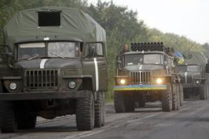 Ukrainian servicemen are seen inside army vehicles …