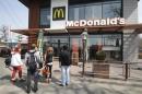 People gather outside a McDonald's restaurant, which was earlier closed for clients, in the Crimean city of Simferopol April 4, 2014. REUTERS/Stringer