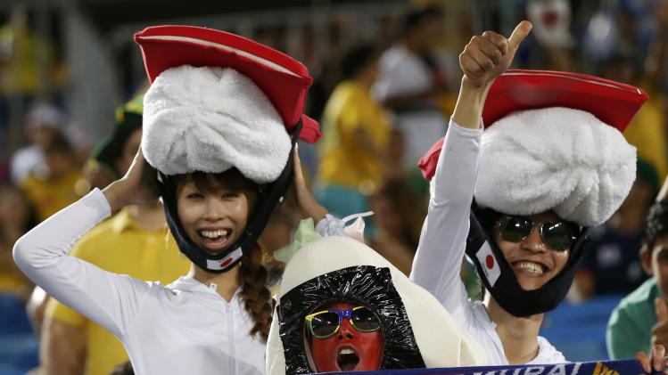 Fans of Japan&#39;s national soccer team cheer ahead of their 2014 World Cup Group C soccer match against Greece at the Dunas arena in Natal