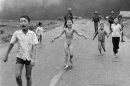 FILE - In this June 8, 1972 file photo, crying children, including 9-year-old Kim Phuc, center, run down Route 1 near Trang Bang, Vietnam after an aerial napalm attack on suspected Viet Cong hiding places as South Vietnamese forces from the 25th Division walk behind them. A South Vietnamese plane accidentally dropped its flaming napalm on South Vietnamese troops and civilians. From left, the children are Phan Thanh Tam, younger brother of Kim Phuc, who lost an eye, Phan Thanh Phouc, youngest brother of Kim Phuc, Kim Phuc, and Kim's cousins Ho Van Bon, and Ho Thi Ting. (AP Photo/Nick Ut)