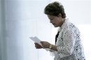 Brazil's President Dilma Rousseff reads a piece of paper at an event for the announcement of measures to expand the Affectionate Brazil Program in Brasilia
