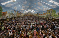 Visitors enjoy the opening day of the famous Bavarian "Oktoberfest" beer festival in the 'Hacker Pschorr' beer tent in Munich, southern Germany, Saturday, Sept. 22, 2012. The world's largest beer festival, is held from Sept. 22 to Oct. 7, 2012 and will see some million visitors. (AP Photo/Matthias Schrader)