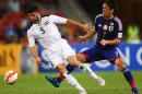 Yasuhito Endo (R) of Japan fights for the ball with Iraq's Yaser Safa Kasim during their first round AFC Asian Cup match, at the Suncorp Stadium in Brisbane, on January 16, 2015