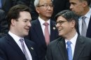 Britain Chancellor of the Exchequer George Osborne, left, talks with U.S. Treasury Secretary Jack Lew during a group photo of the G20 finance ministers and central bank governors on the sidelines of their meeting at World Bank Group International Monetary Fund Spring Meetings in Washington, Friday, April 19, 2013. (AP Photo/Charles Dharapak)