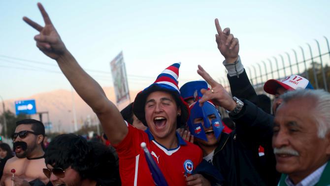 Fans of Chile cheer before their Copa America soccer match against Mexico at the National Stadium in Santiago