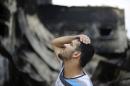 A Palestinian looks at his family's food factory, which witnesses said was shelled and torched by the Israeli army during the offensive, in Deri al Balah in central Gaza Strip