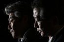 Nomura Holdings Inc outgoing Chief Executive Watanabe sits beside incoming Chief Executive Nagai at a news conference in Tokyo
