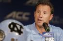 FILE - In this July 21, 2014, file photo, North Carolina coach Larry Fedora answers a question during a news conference at the Atlantic Coast Conference football kickoff in Greensboro, N.C. Fedora says the team has suspended four players for this weekend's season opener, a day after a report of an alleged hazing altercation left a walk-on receiver with a possible concussion. Fedora said Wednesday, Aug. 27, the four players were suspended for a "violation of team policy," but offered no other details about what rules were broken. (AP Photo/Chuck Burton, File)