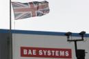 A union flag flies over the entrance to the naval dockyards, where BAE Systems are also located, in Portsmouth
