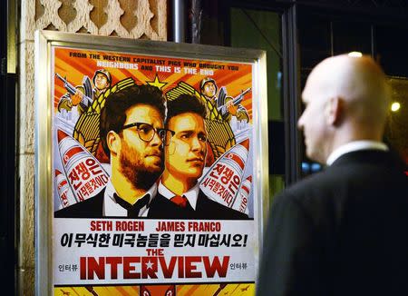 File photo of a security guard standing at the entrance of United Artists theater during the premiere of the film &quot;The Interview&quot; in Los...