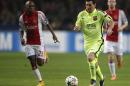 Barcelona's Lionel Messi vies for the ball with Ajax's Thulani Serero, left, during the Group F Champions League match between AFC Ajax and FC Barcelona at ArenA stadium in Amsterdam, Netherlands, Wednesday, Nov. 5, 2014. (AP Photo/Peter Dejong)