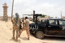 Fighters from the pro-government forces loyal to Libya's Government of National Unity (GNA) hold a position as they target the Islamic State (IS) group in Sirte on June 23, 2016