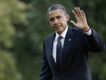 U.S. President Obama waves as he returns to the White House in Washington