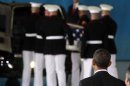 U.S. President Obama watches as the body of an American killed in Benghazi this week is placed in a hearse during a return of remains ceremony at Andrews Air Force Base near Washington