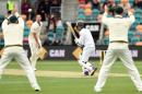 South Africa's Quinton de Kock (C) plays a defensive shot off Australia's paceman Josh Hazlewood (2nd L) on the third day's play of the second Test cricket match between Australia and South Africa in Hobart remained on November 14, 2016