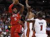 Atlanta Hawks' Josh Smith (5) prepares to shoot over Miami Heat's Shane Battier, center, and Chris Bosh in the first half of an NBA basketball game, Monday, Dec, 10, 2012, in Miami. (AP Photo/Alan Diaz)