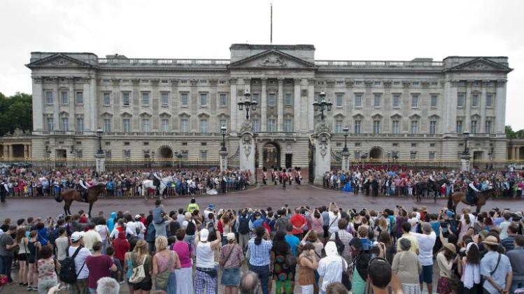 File picture shows crowds outside Buckingham Palace in central London watching as guardsmen take part in the Changing of the Guard ceremony on July 23, 2013