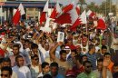 Anti-government protesters shout slogans as they march on main highway of Jidhafs during protest calling for more reforms and change