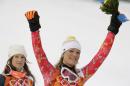 Women's supercombined gold medal winner Germany's Maria Hoefl-Riesch and bronze medal winner United States' Julia Mancuso celebrate after a flower ceremony at the Sochi 2014 Winter Olympics, Monday, Feb. 10, 2014, in Krasnaya Polyana, Russia. (AP Photo/Charles Krupa)
