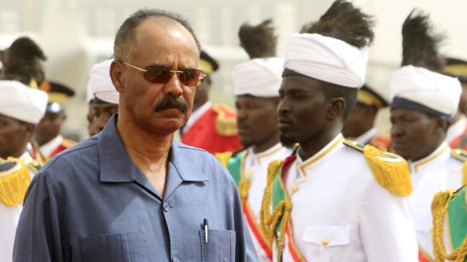 Eritrean President Isaias Afwerki (L) reviews the honor guard during his welcome ceremony in the Sudanese capital, Khartoum, on June 11, 2015