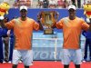 Bob and Mike Bryan of the U.S. hold the trophy after winning the men's doubles final against Argentina's Berlocq and Uzbekistan's Istomin at the China Open tennis tournament in Beijing